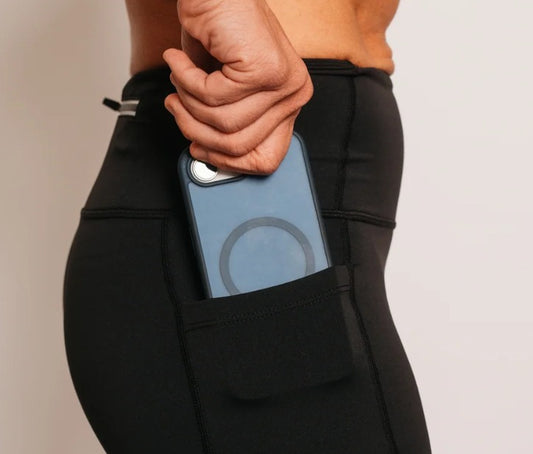 Close-up of the Flex Shorts phone pocket holding a phone