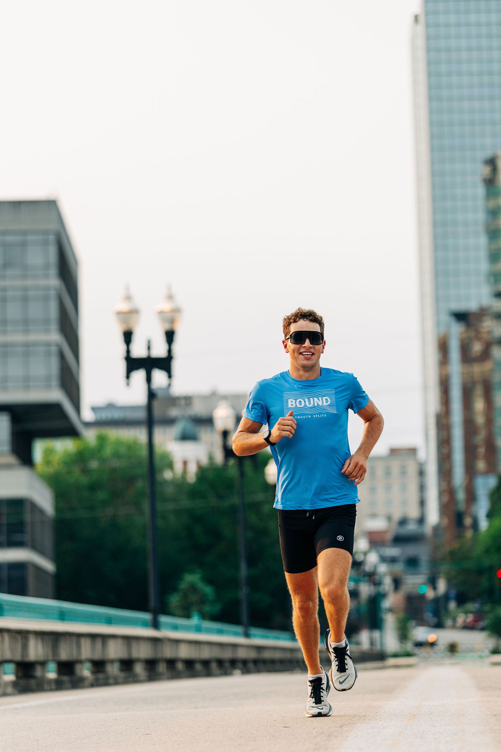 Runner in the Smooth Splits Short Sleeve running toward camera downtown