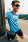 Runner in the Smooth Splits Short Sleeve stretching on a bridge