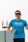 Runner wearing the Smooth Splits Short Sleeve on a city bridge