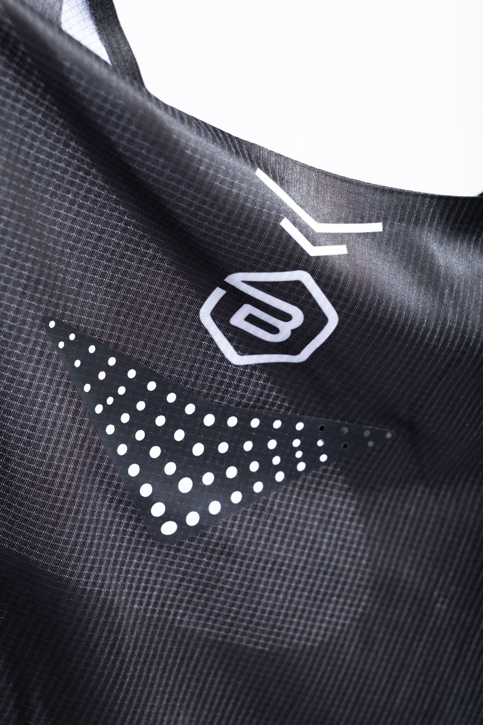 Close-up of PR Singlet fabric with laser-cut air holes and BOUND logo