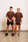 The Off-Day Tee on a man and a woman, showing the unisex oversized fit on both