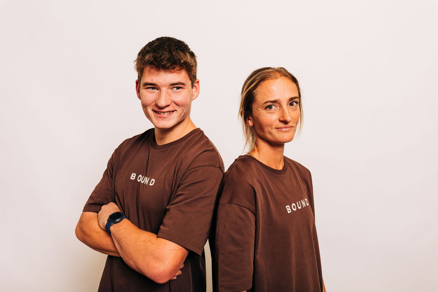 Two people wearing The Off-Day Tee in brown side by side