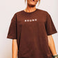 The Off-Day Tee in brown, front close-up showing the heavyweight cotton and boxy oversized fit
